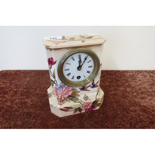 149 - Ceramic cased mantel clock with white enamel dial, the case decorated with birds and foliage, the mo... 