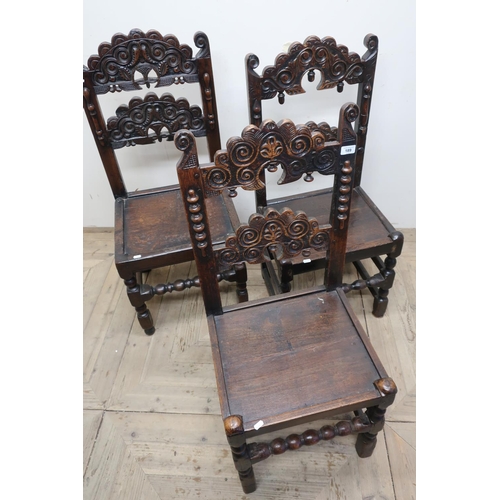 189 - Set of three similar carved oak dining chairs with solid seats, on bobbin turned supports