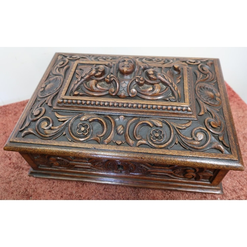 195 - Elaborately carved rectangular oak table box with hinged lift up lid and light oak fitted interior, ... 