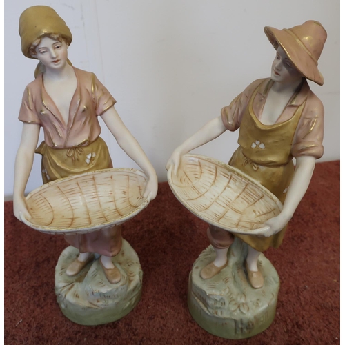 3 - Pair of Royal Dux figures in the form of a lady and gentleman carrying baskets, with shamrock detail... 