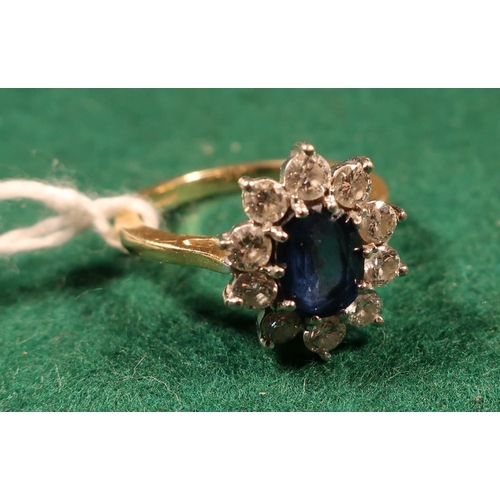 368 - 18ct gold diamond and sapphire flower head ring with large oval faceted sapphire surrounded by ten d... 