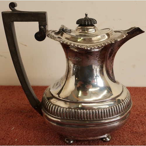 379 - Edwardian silver teapot of ballaster form, gadrooned rim with ribbed base, ebony handles and finial,... 