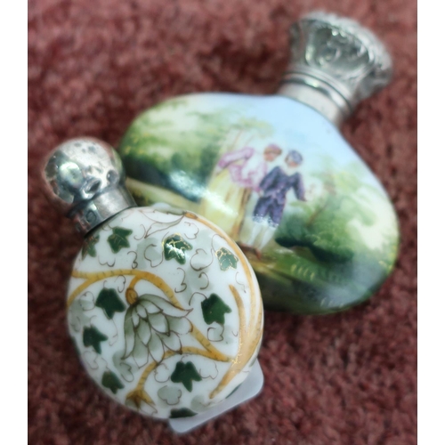 402 - Two porcelain bodied scent bottles with silver hallmarked tops (2)