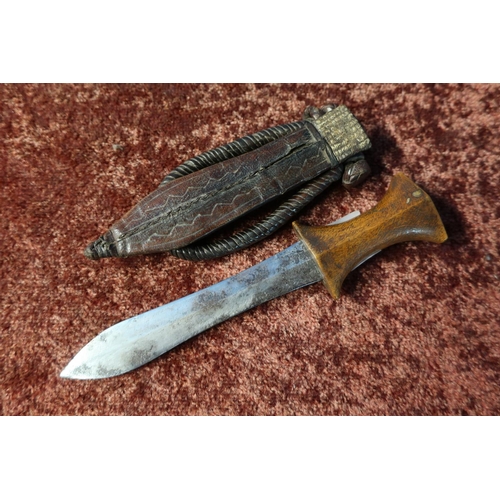 33 - North African arm dagger with 5 1/2 inch swollen blade, wooden grip and leather sheath with braided ... 