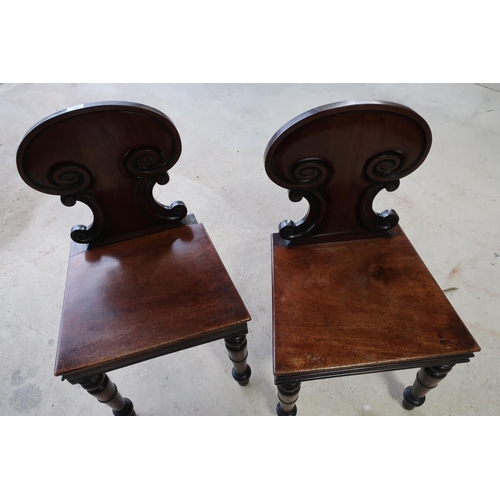 395 - Pair of early 19th C mahogany chairs with solid backs and seats, on turned supports