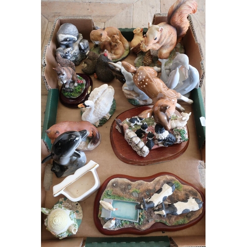 17 - Resin figure of a Red Squirrel, other pottery and resin animal ornaments including Foxes, Dolphins c... 