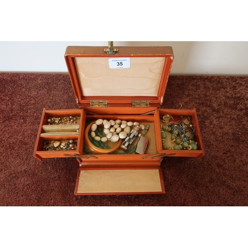 35 - Tan pigskin silk lined cantilever jewellery box containing a selection of costume and other jeweller... 