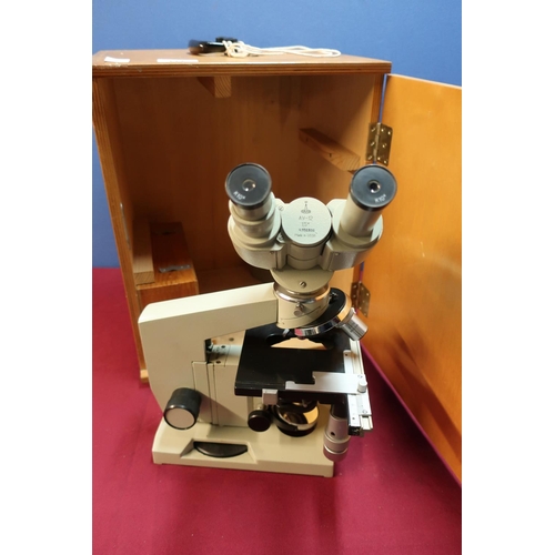 111 - Wooden cased Russian Lomo binocular microscope in fitted case with key, with light source and all ac... 