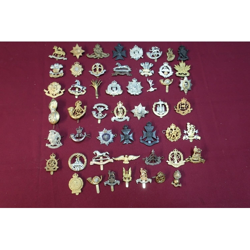 116 - Box containing approximately fifty various assorted British, Canadian and other military cap badges