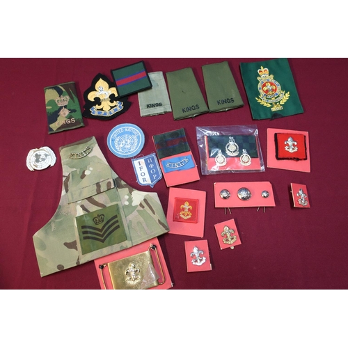 13 - Box containing a quantity of Kings regiment insignia including rank slides, cap badges, shoulder tit... 