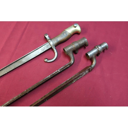 18 - Two 19th C socket triangular form bayonets and a French bayonet, the top strap marked 1880 (3)