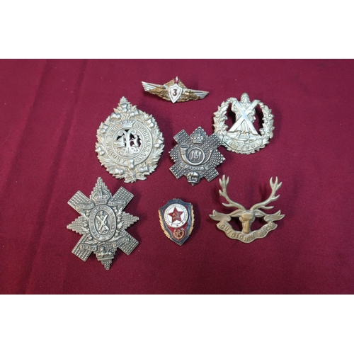 22 - Small selection of Scottish cap badges including Highland Light Infantry and two Soviet Union enamel... 
