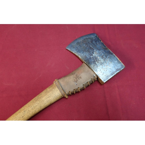 87 - Sheffield steel axe with wooden shaft and leather mounts with traces of stamped detail to the head '... 