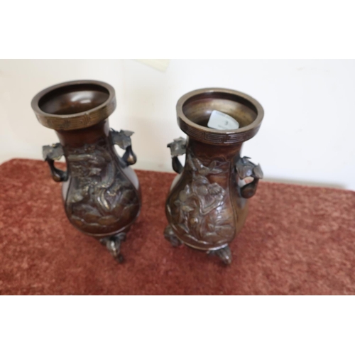 3 - Pair of Japanese bronze vases on elephant head supports, with floral panel detail to the bodies (26.... 