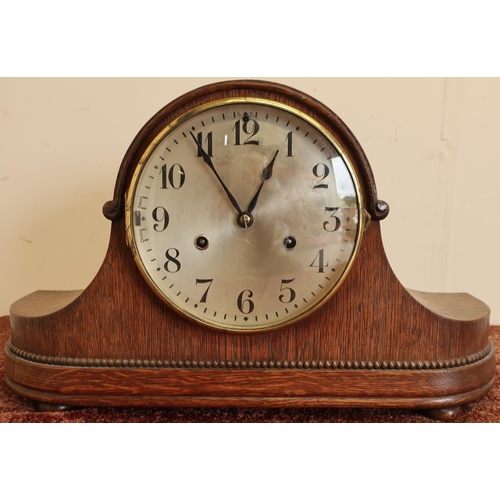 92 - Early 20th C oak cased mantel clock with steel dial on four raised bun feet, the chiming movement ma... 