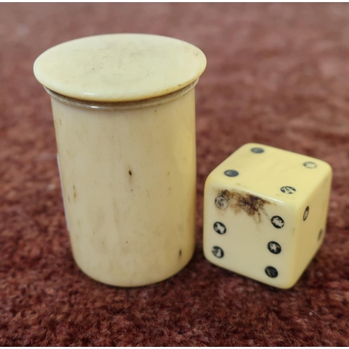 22 - 19th C turned bone container with bobbin type device and a carved bone dice