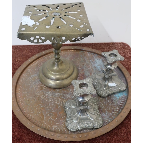 29 - 19th C brass trivet stand, a circular brass tray and two silver plated candlesticks