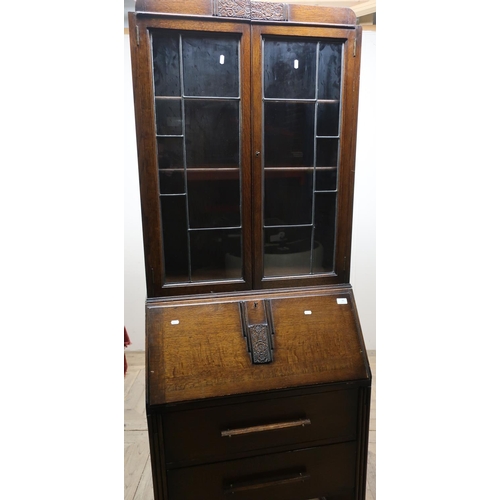 65 - Circa 1920s oak bureau bookcase with two lead glazed doors above fall front and two drawers (width 7... 