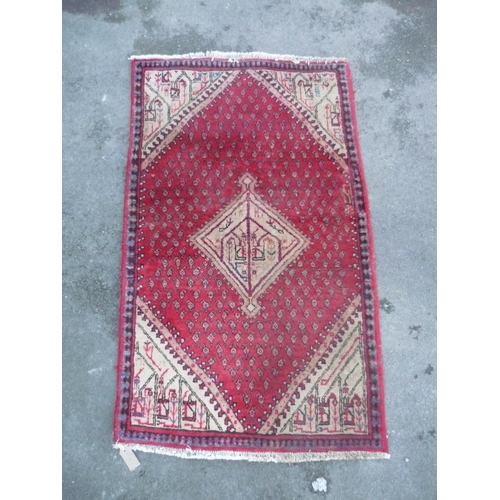 283 - Traditional Middle Eastern red ground patterned rug with central beige medallion and beige ground pa... 