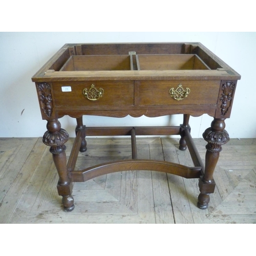 216 - Oak two drawer side table on elaborately carved supports with T shaped under stretcher (lacking top)... 