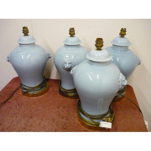 197 - Set of four ceramic table lamps with lion mask handles