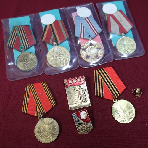 27 - Group of six Soviet Russian medals and three Russian badges including USSR Medal Celebrating 60 Year... 