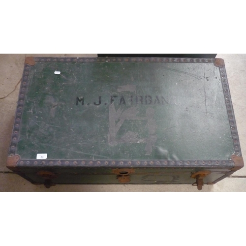 22 - Large travelling trunk with the name M J Fairbank and metal fastenings