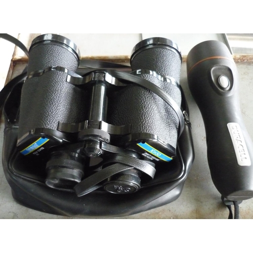 55 - Cased Tasco pair of binoculars, and a Duracell torch