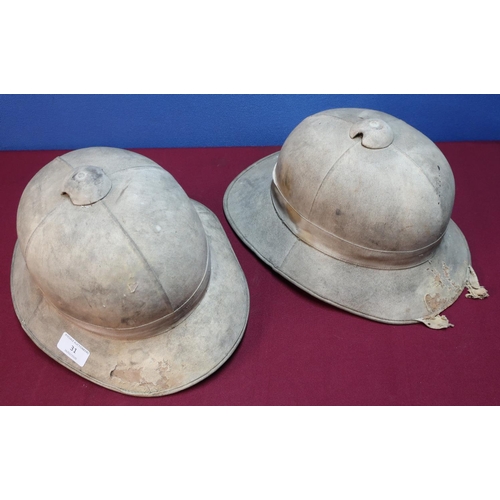 31 - Two circa WWII period British military pith helmets, one with leather liner and chin strap marked Ve... 