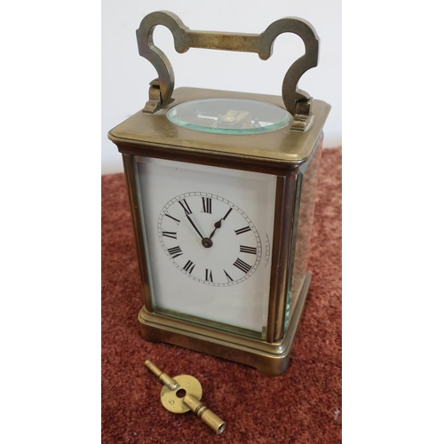 480 - Large brass cased carriage clock with bevelled edge glass panels and striking movement, with key (9.... 