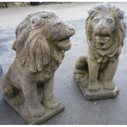 524 - Pair of apposing concrete well weathered sitting lions