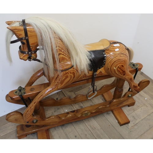 123 - Ian Armstrong wooden carved rocking horse with makers plaque (height 100cm)