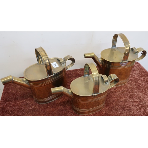 521 - Set of three graduating oval bodied copper watering cans, with ribbed detail