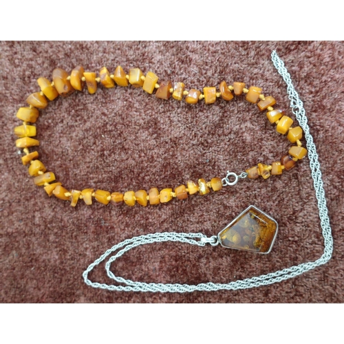 559 - Hand tied strung amber necklace and a modern silver and amber pendant necklace (2)