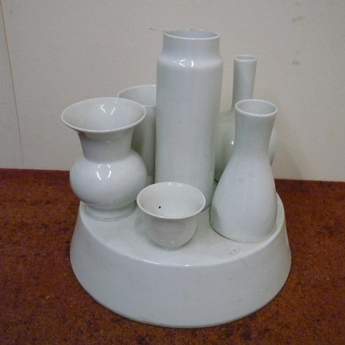 594 - White glazed Chinese ceramic pattern sample on circular base (25cm high)