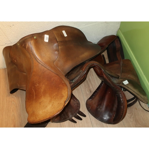 531 - Two leather saddles, one by Fox Saddlers, Wetherby, and a driving girth (3)