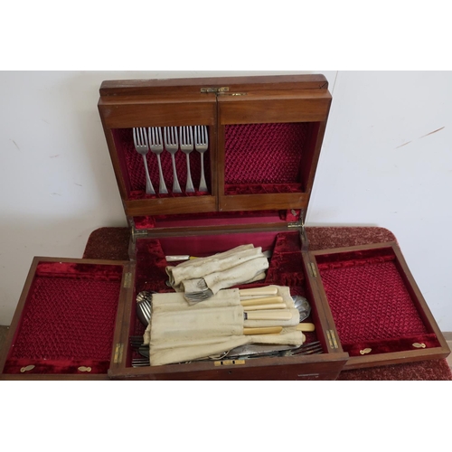 569 - Mahogany sectional canteen of cutlery with various fold out compartments containing a quantity of va... 