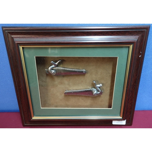 485 - Framed & mounted display of a pair of steel locks for a hammer gun (33cm x 28cm)