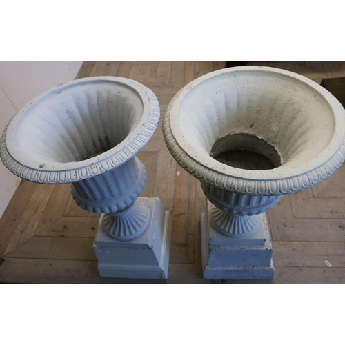 149 - Pair of Victorian cast metal garden urns on square tapering plinths (height 66cm)