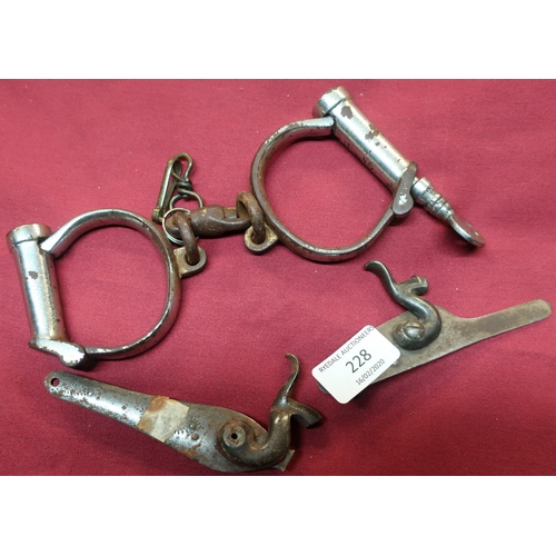 228 - Pair of British Steel handcuffs and two percussion cap gun locks