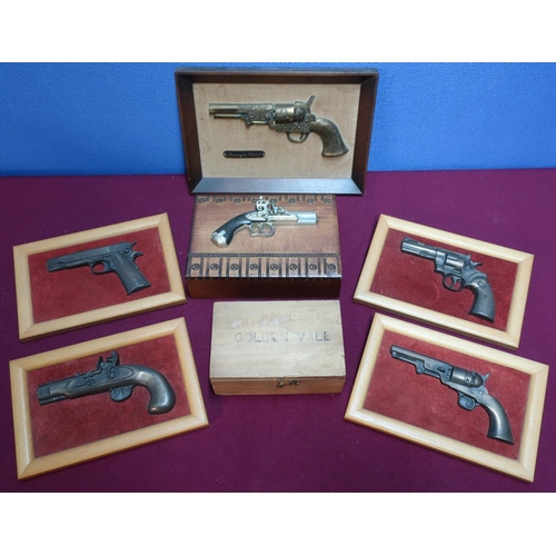 236 - Wooden cigar box topped with a figure of a flintlock pistol, a set of four framed plaques of various... 