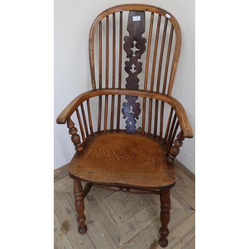 114 - Yew and elm wood stickback Windsor armchair with H shaped understretcher on turned supports