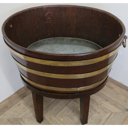 121 - Large oval twin handled brass coopered oak planter with lift out tin and tray on separate later adde... 