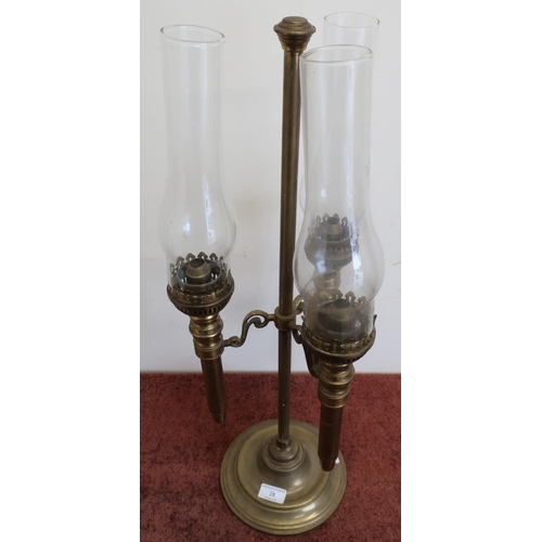 28 - 19th/20th C three branch brass oil lamp with turned circular base complete with chimneys (mounts con... 