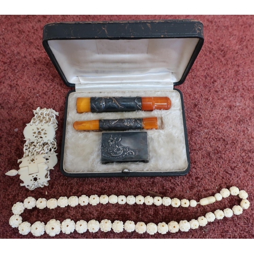 41 - Early 20th C carved articulated ivory bracelet, a similar bead-work bracelet and a cased smoking set... 
