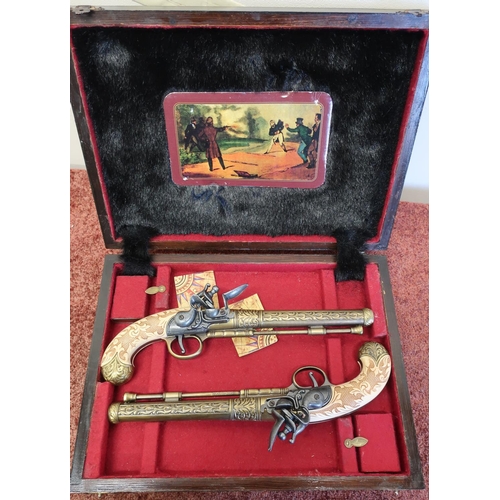 574 - Cased pair of Spanish made reproduction flintlock pistols