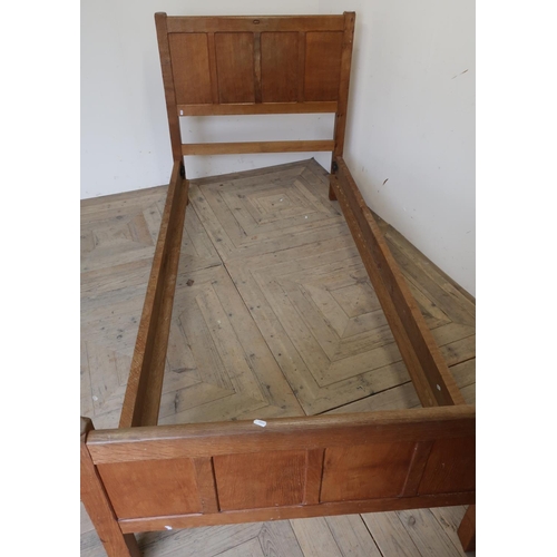 89 - Acorn man oak single bedstead with paneled detail to the head and foot boards maximum width 100cm to... 