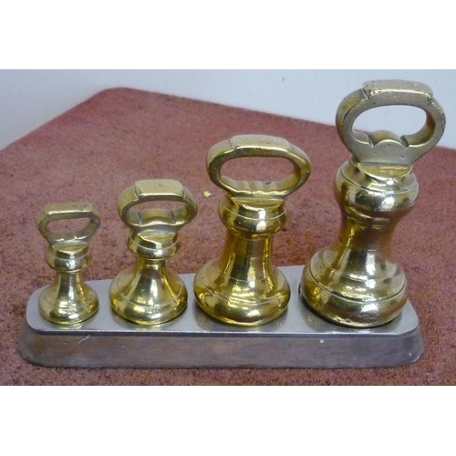 29 - Large Victorian set of four graduating brass weights with stand