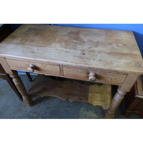 591 - Victorian pine two drawer two tier side table on turned supports (97cm x 48cm x 76cm)