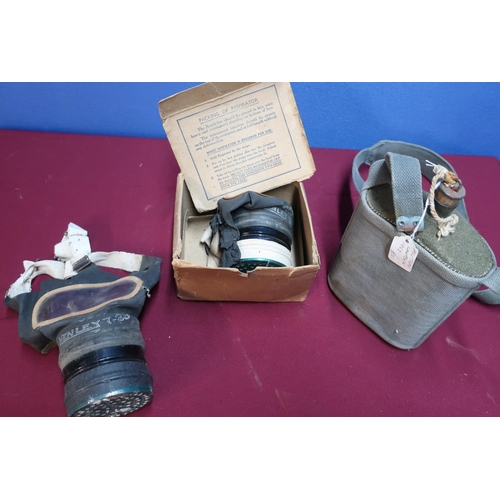 153 - Military canteen with webbing strap, two British issue gas masks